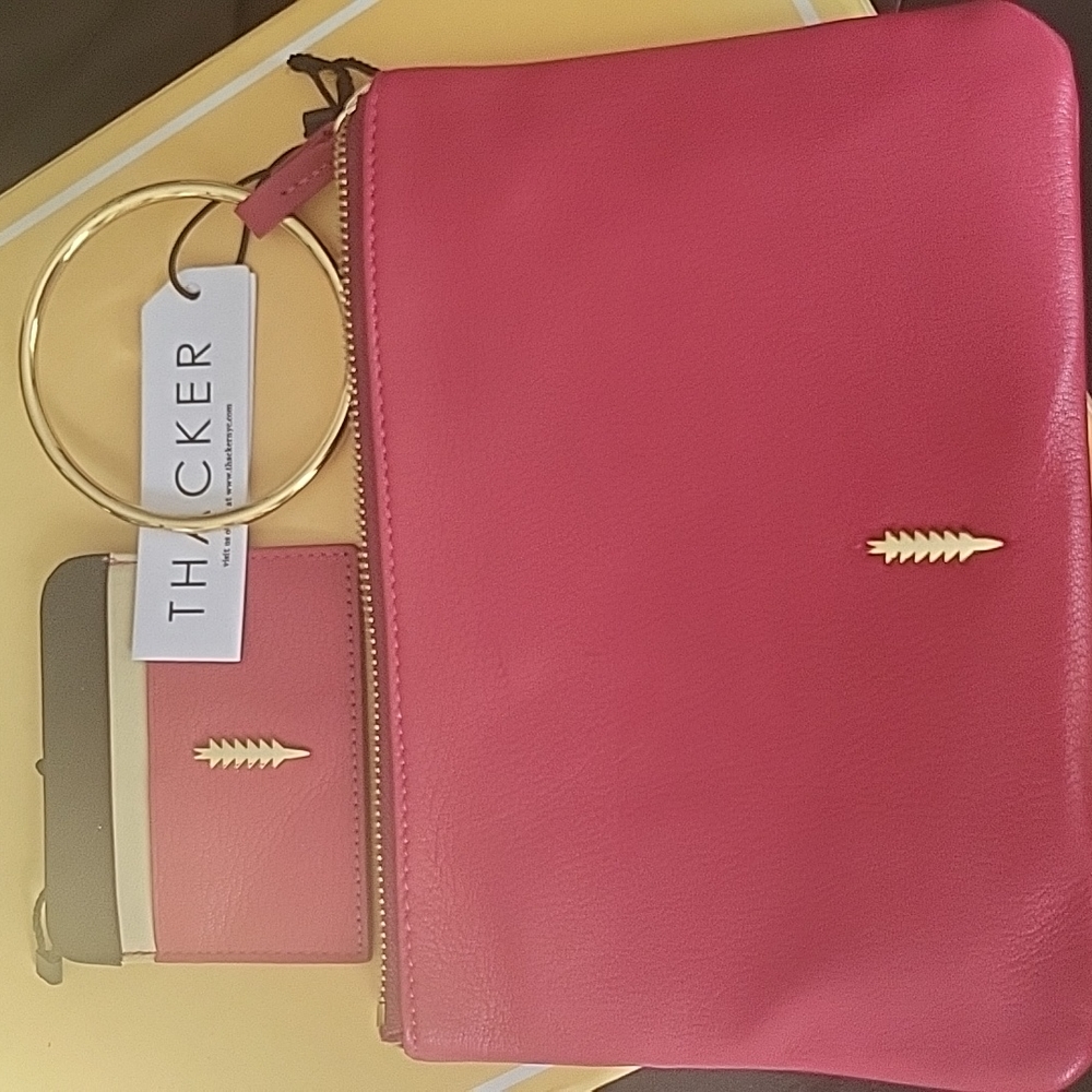 Thacker Red leather wristlet with gold handle. Additional credit card holder